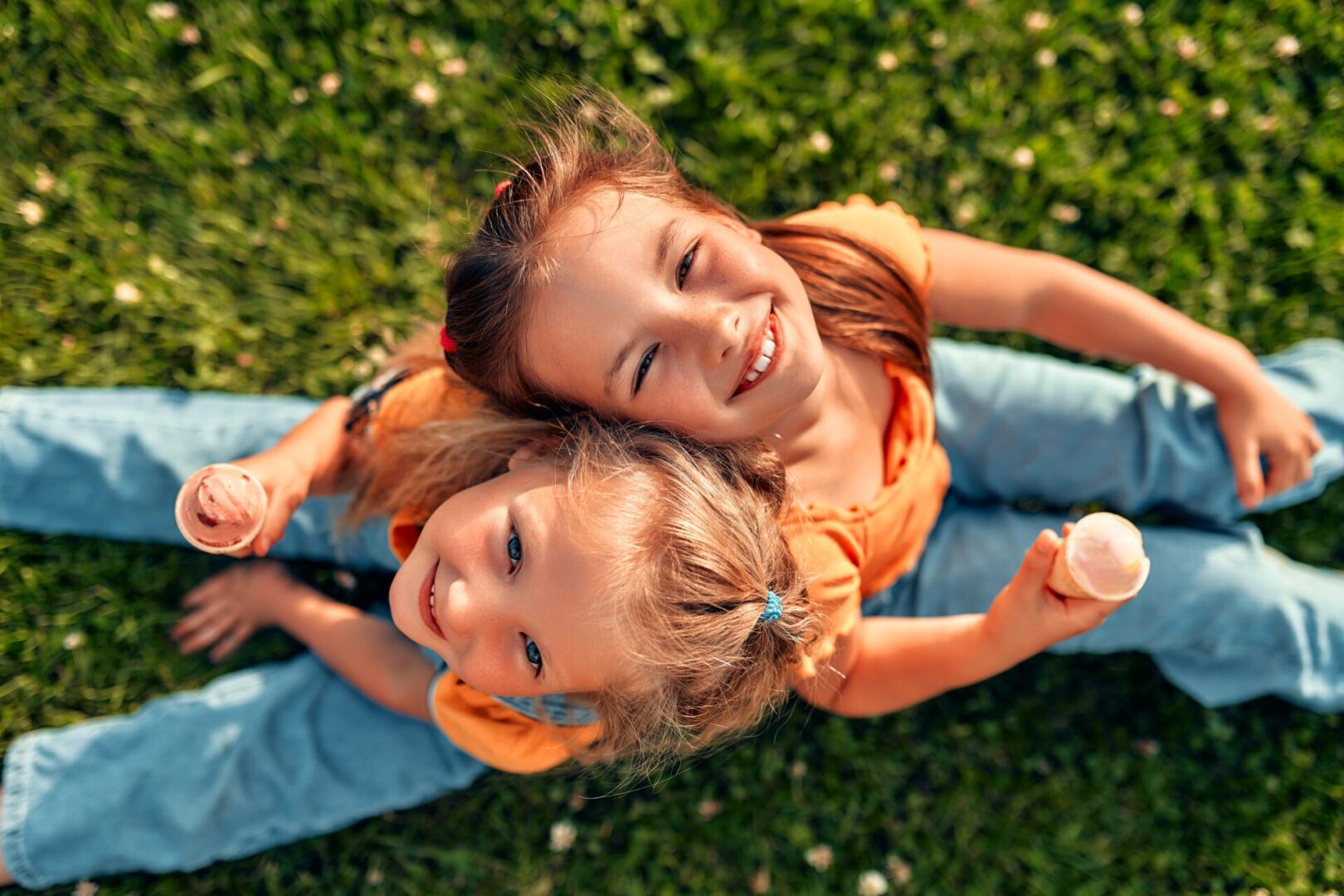 Two,Happy,Little,Sister,Girls,Sitting,In,A,Meadow,On